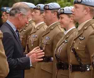 Charles inspecting the troops particular attention on a woman soldier